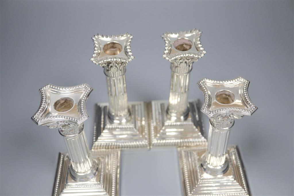 Two pairs of silver corinthian column dwarf candlesticks, Sheffield, 1920 and Sheffield, 1962, 17cm & 16cm.
